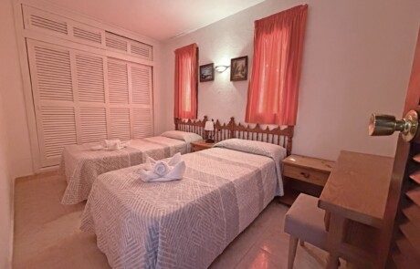 APRYPRTX 23 Twin Bedroom Red Curtains - LeibTour: TOP aparthotels in Ibiza